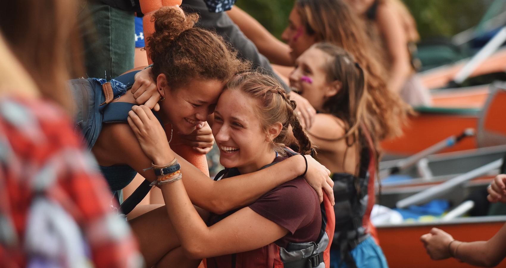 camper and staff hugging