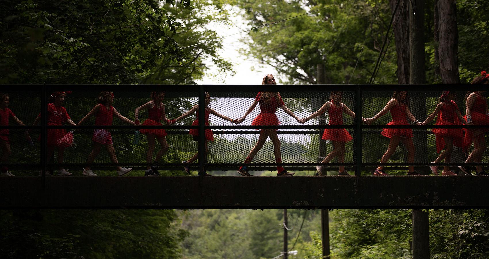 Campers walking over bridge