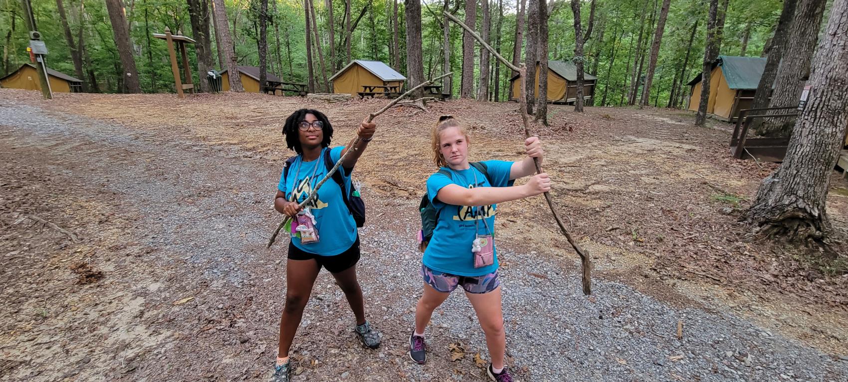 camp staff holding sticks