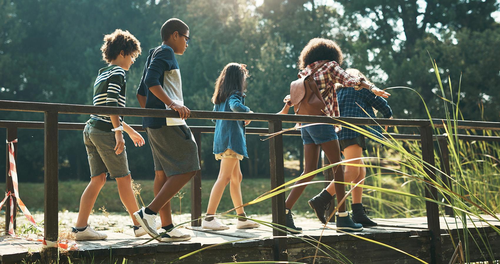 Kids walking over bridge