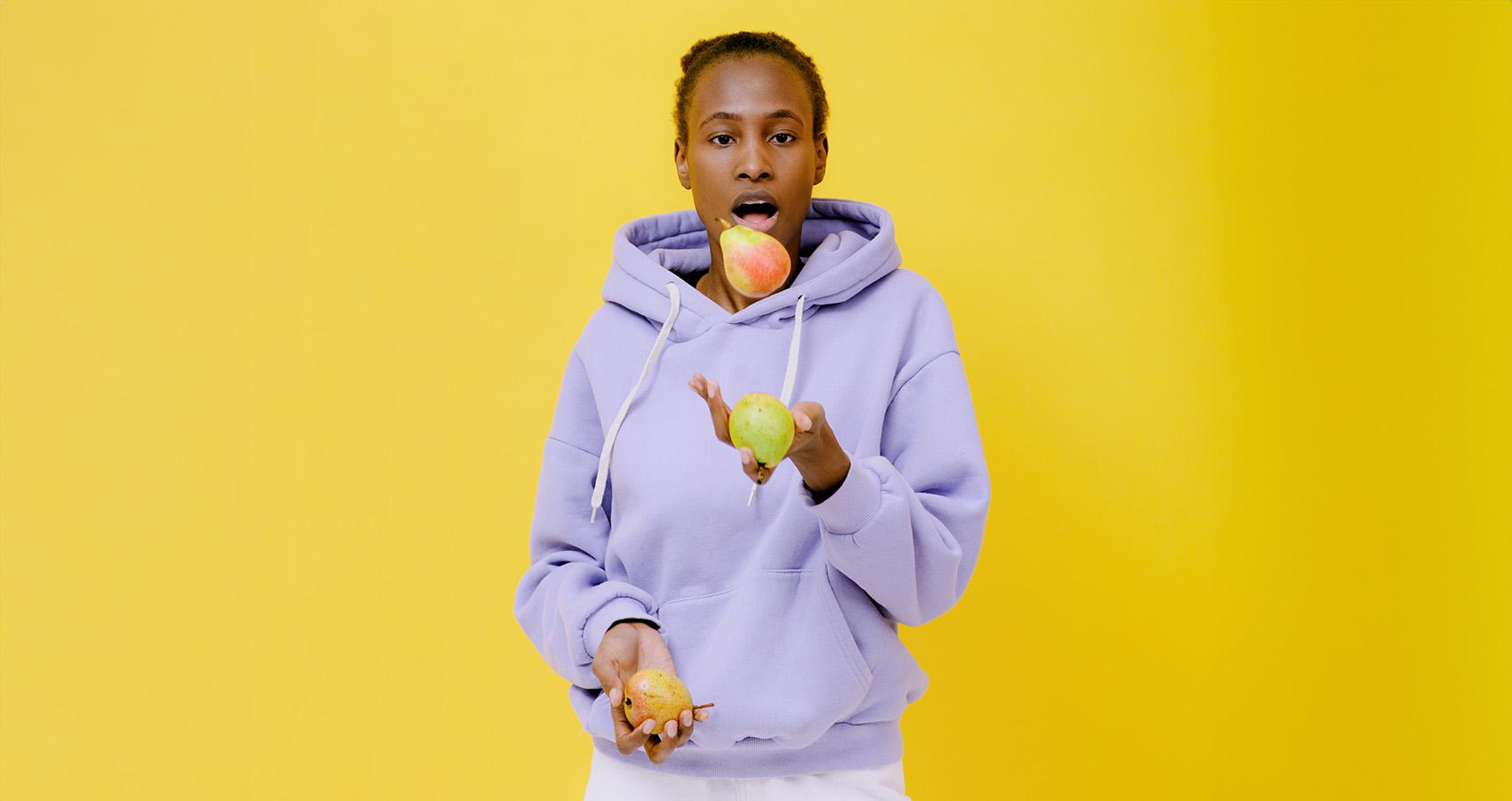 Person juggling fruit