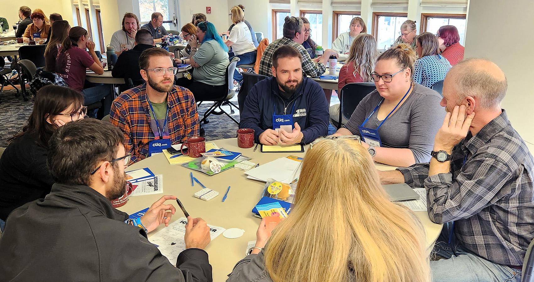 Attendees in discussion at small table