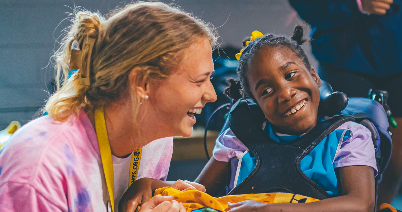camp staff with camper who uses a wheelchair