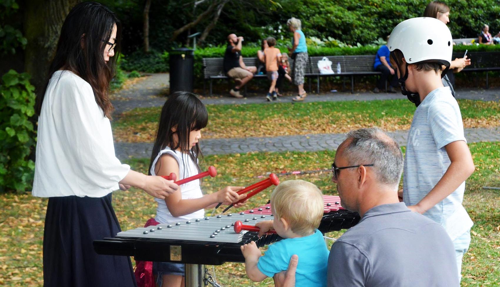 adults and kids playing Duo instrument