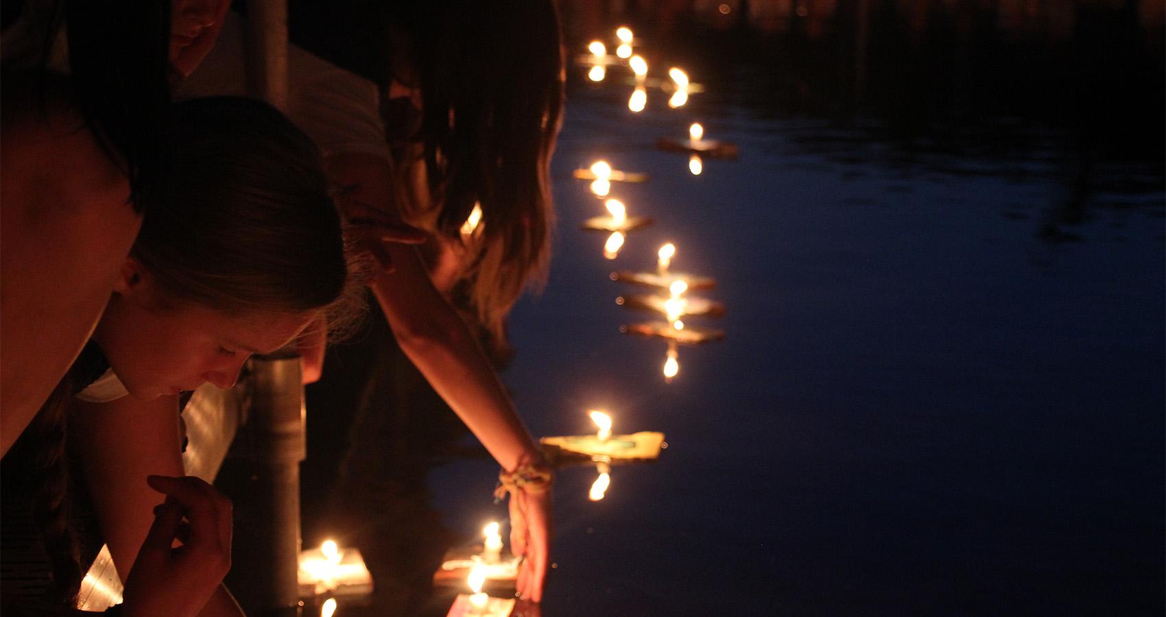 campers releasing wishing boats