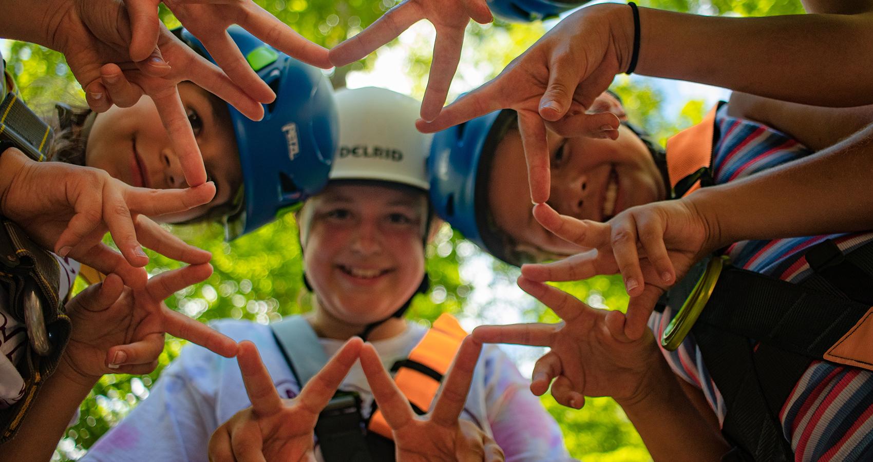 campers making star with fingers