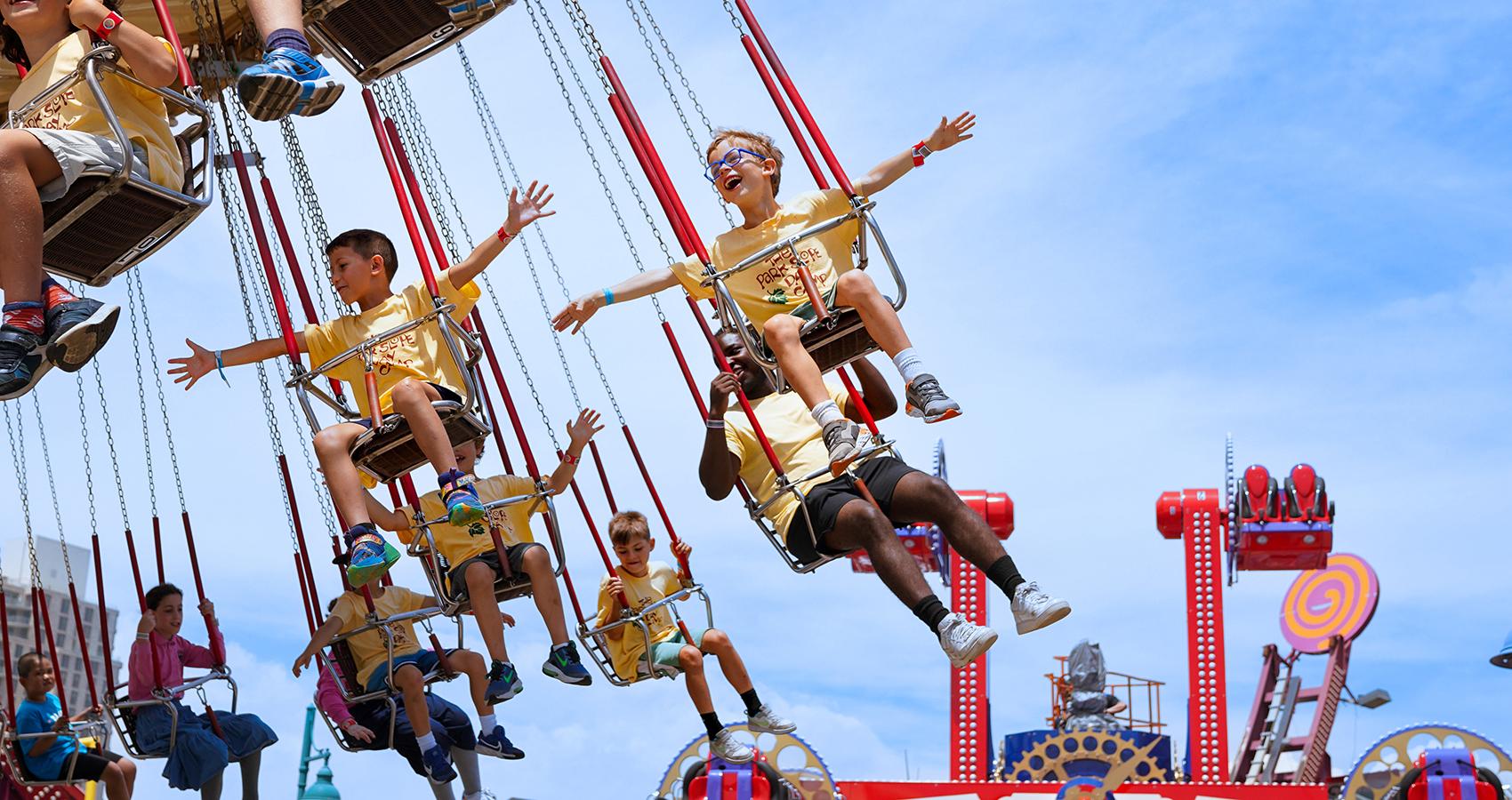 campers on carnival swings