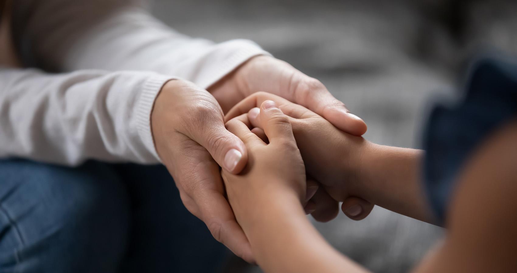 hands of child and parent