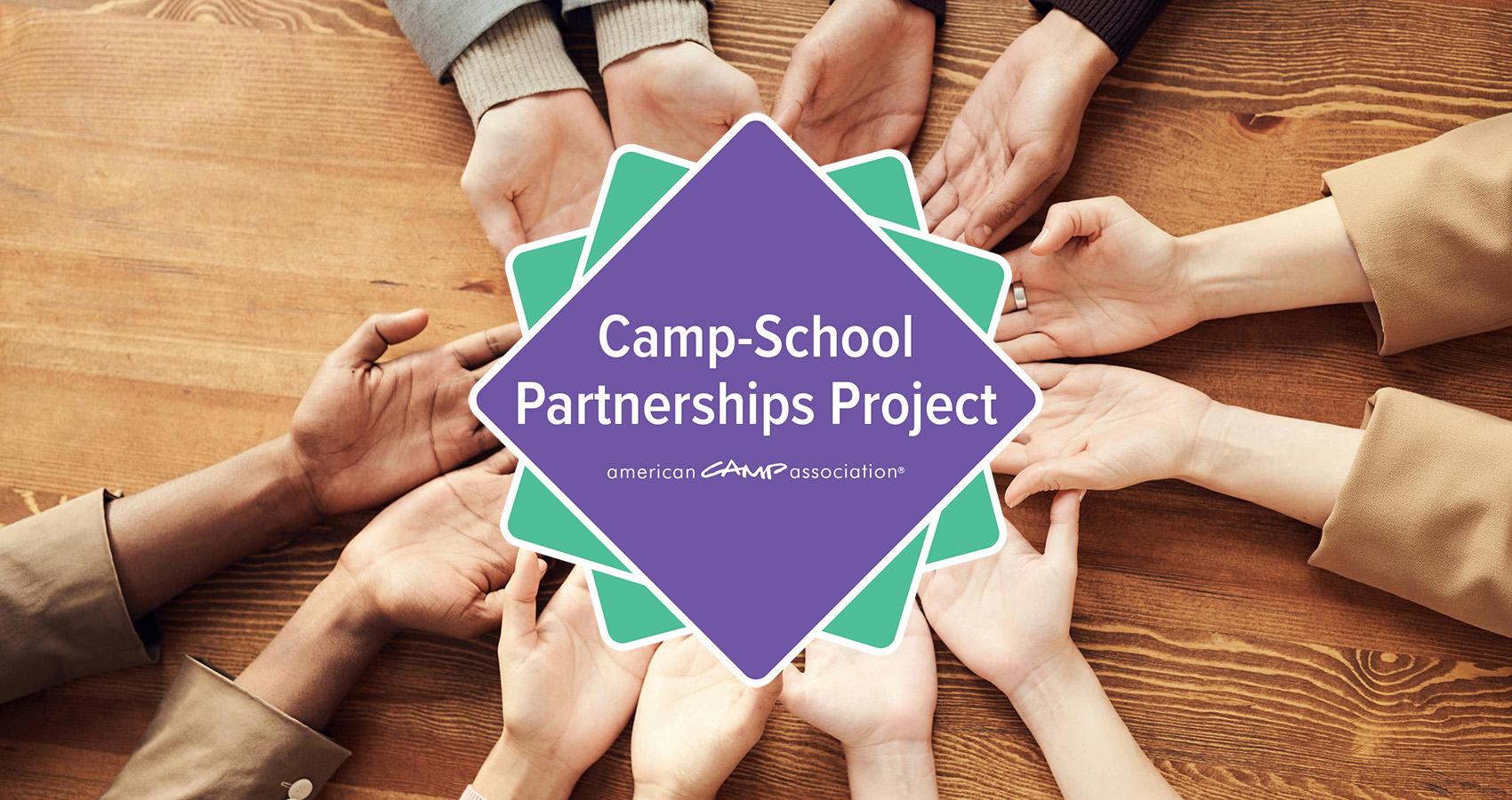 Camp School Partnership logo being held by hands