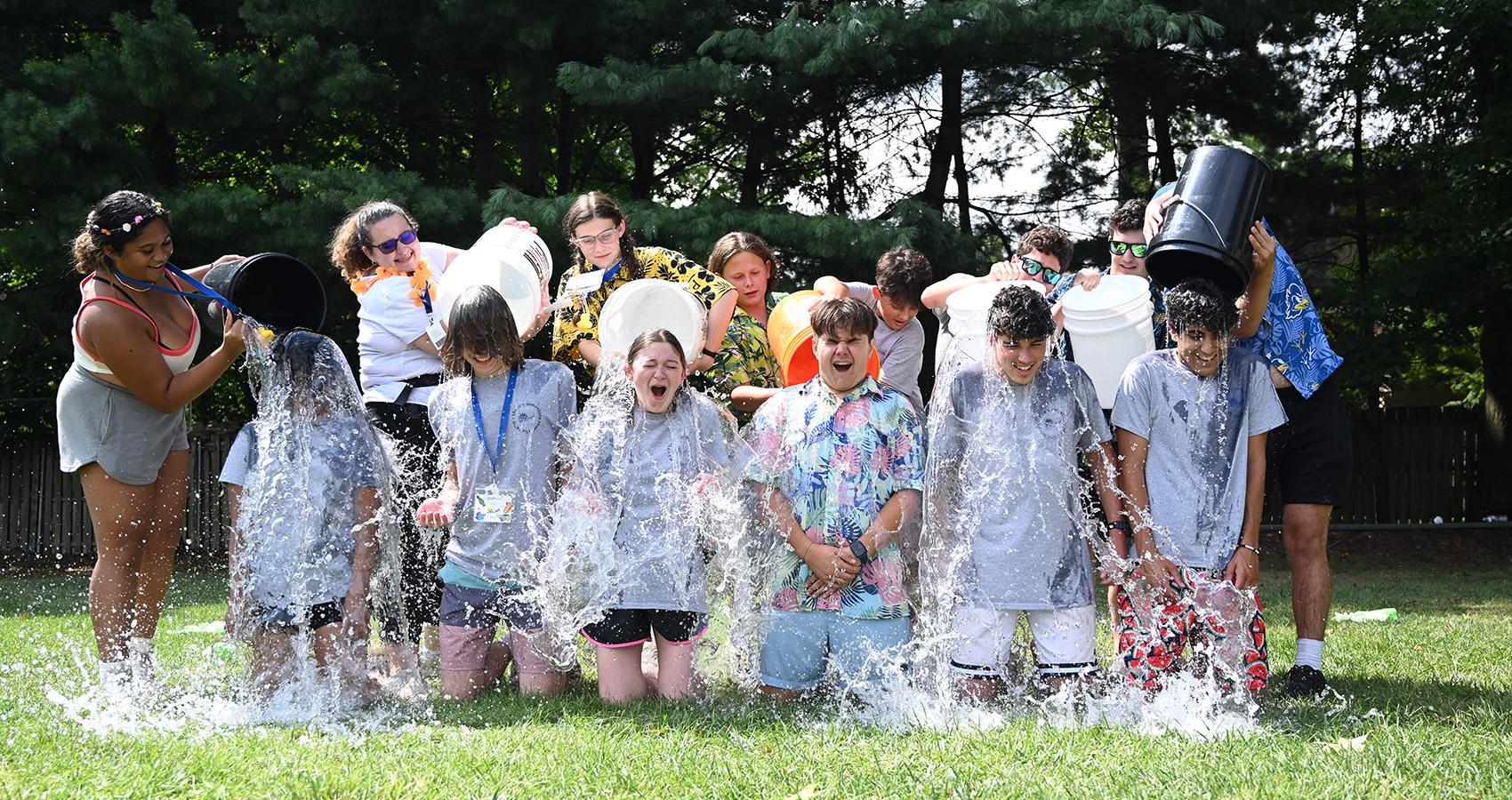 camp staff dumping buckets of water