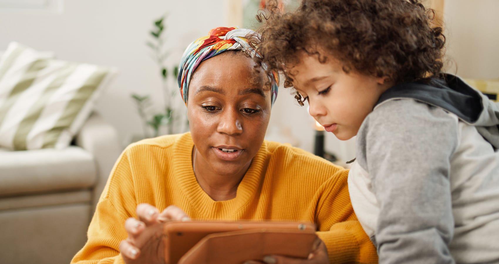 parent and child looking at tablet