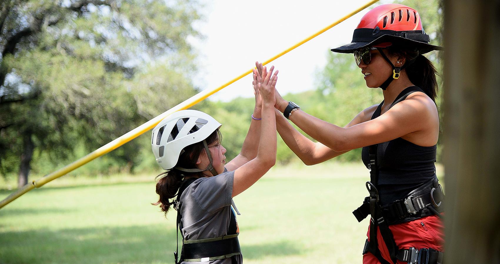 camper and staff high-five