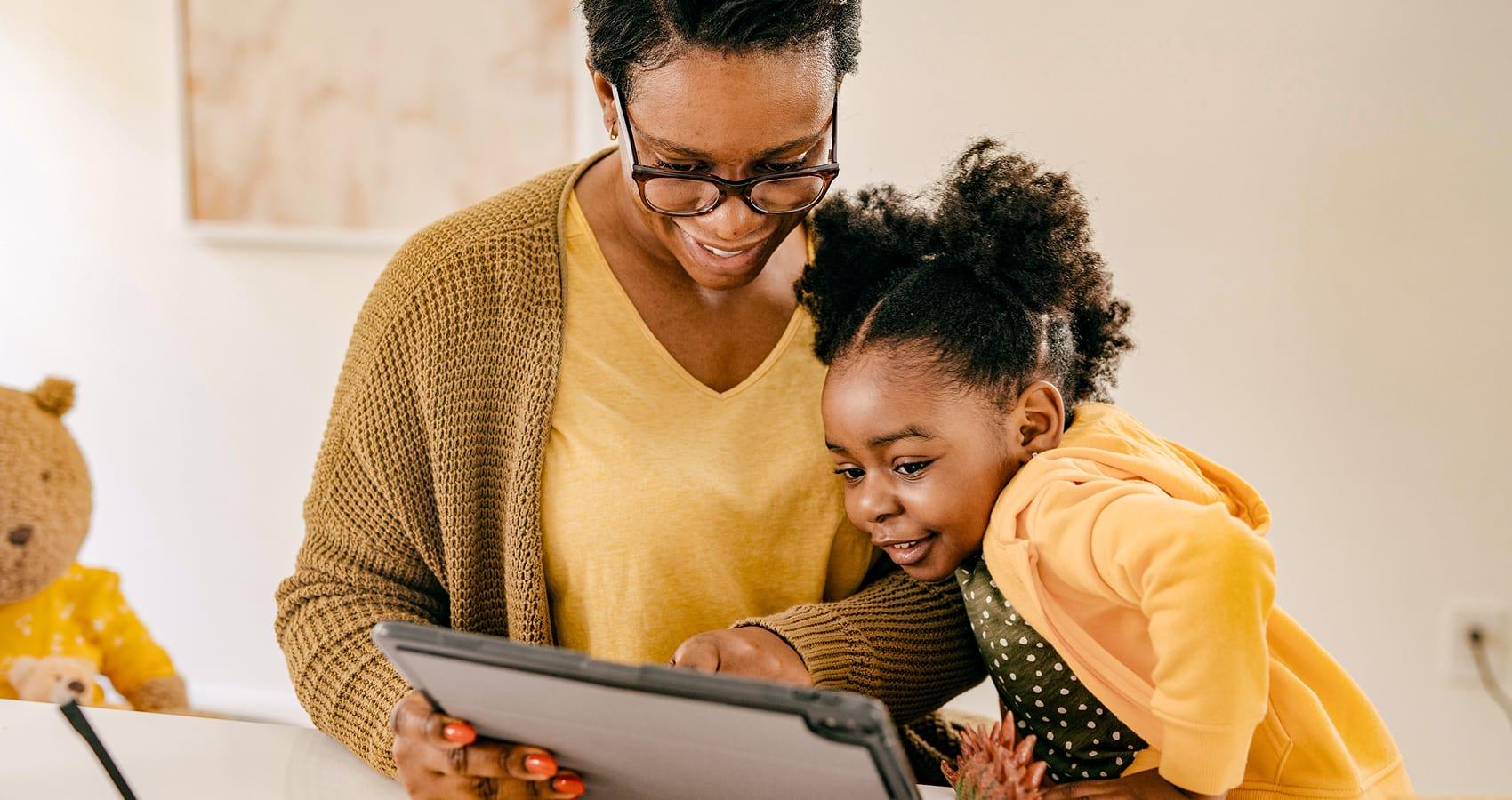 Parent and child looking at tablet