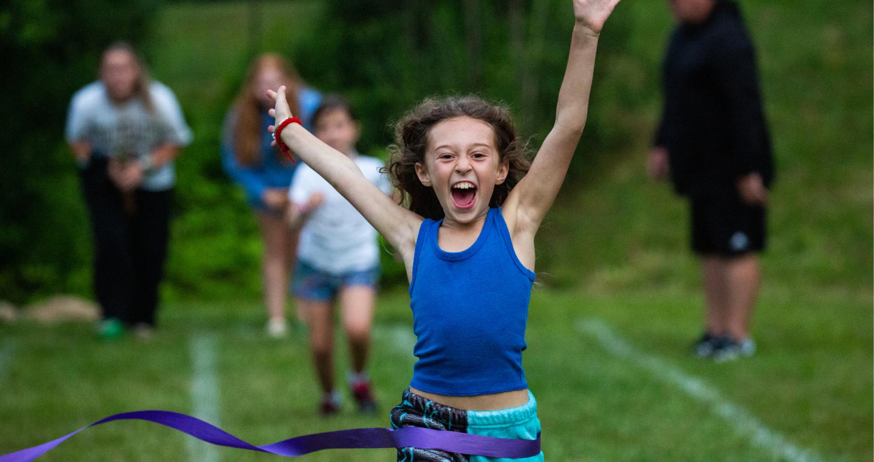 Smiling Camper playing flag football