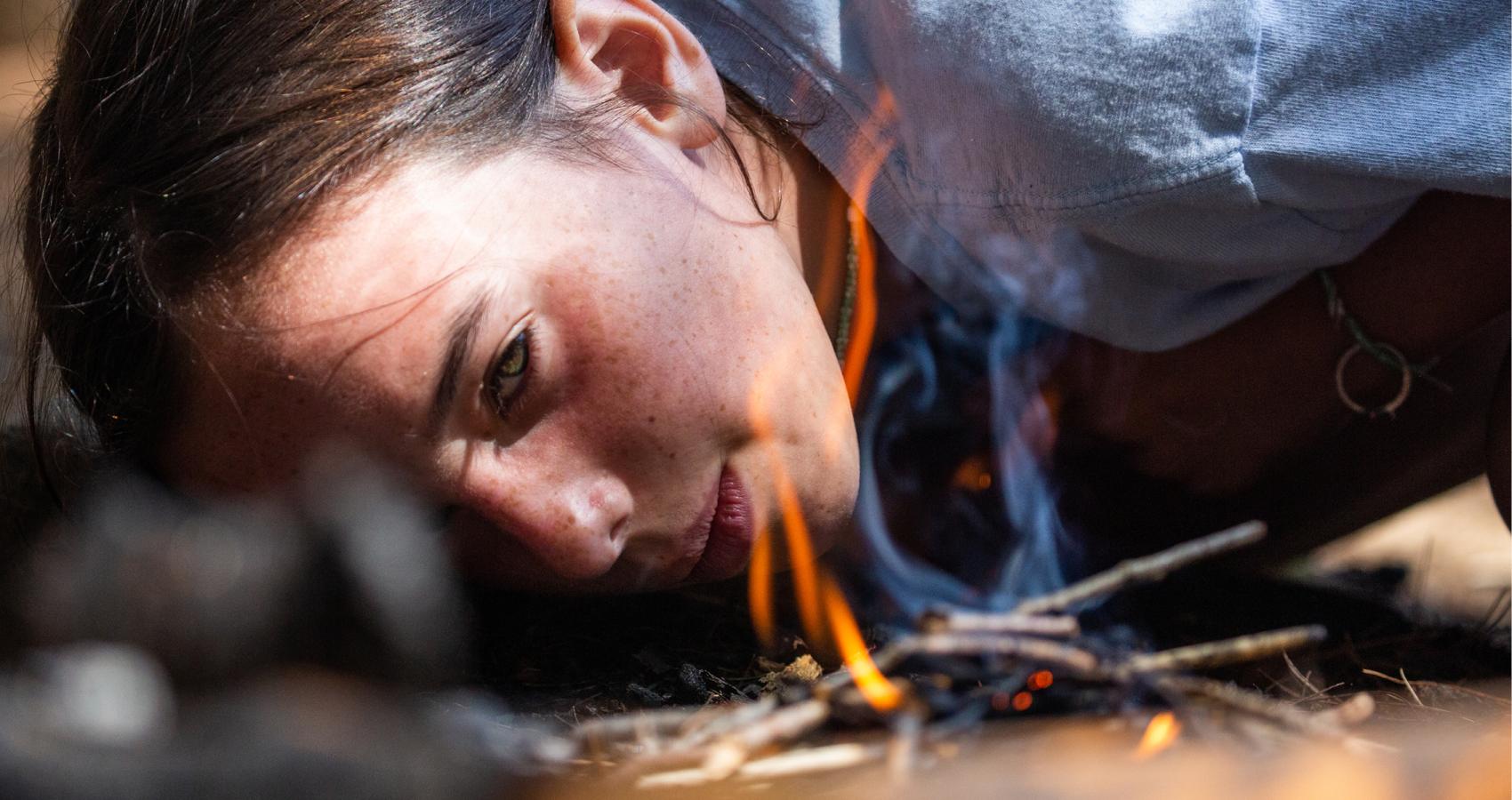 Camper tending to fire