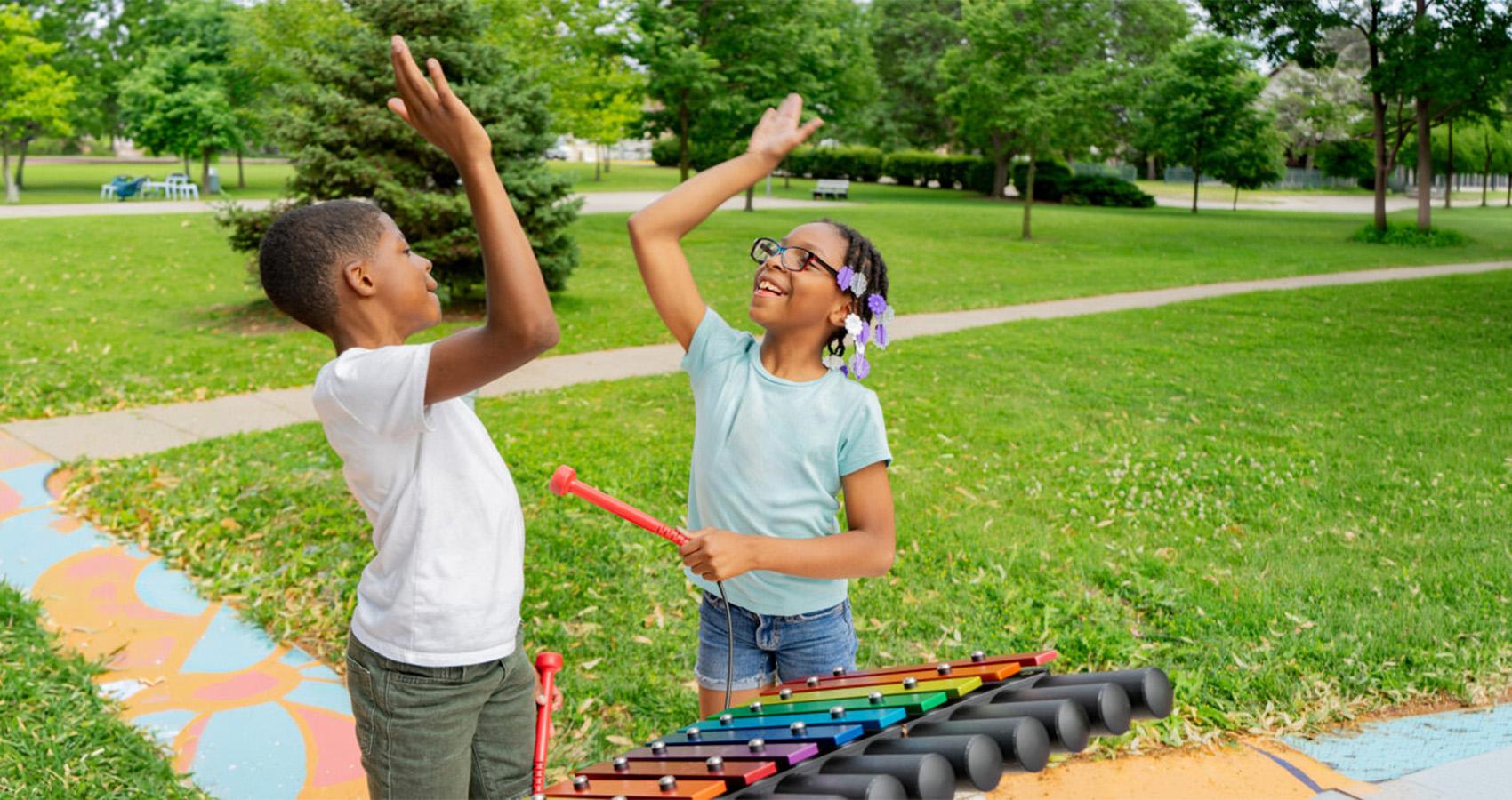 kids having fun with outdoor instrument