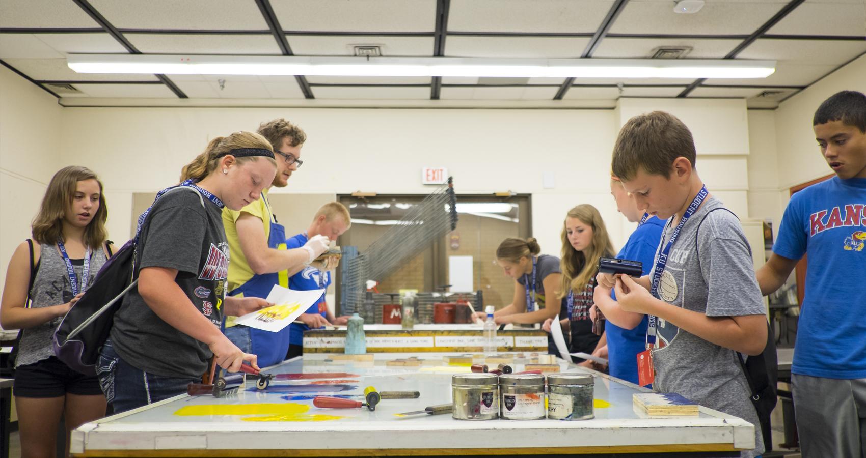 campers painting at an indoor table