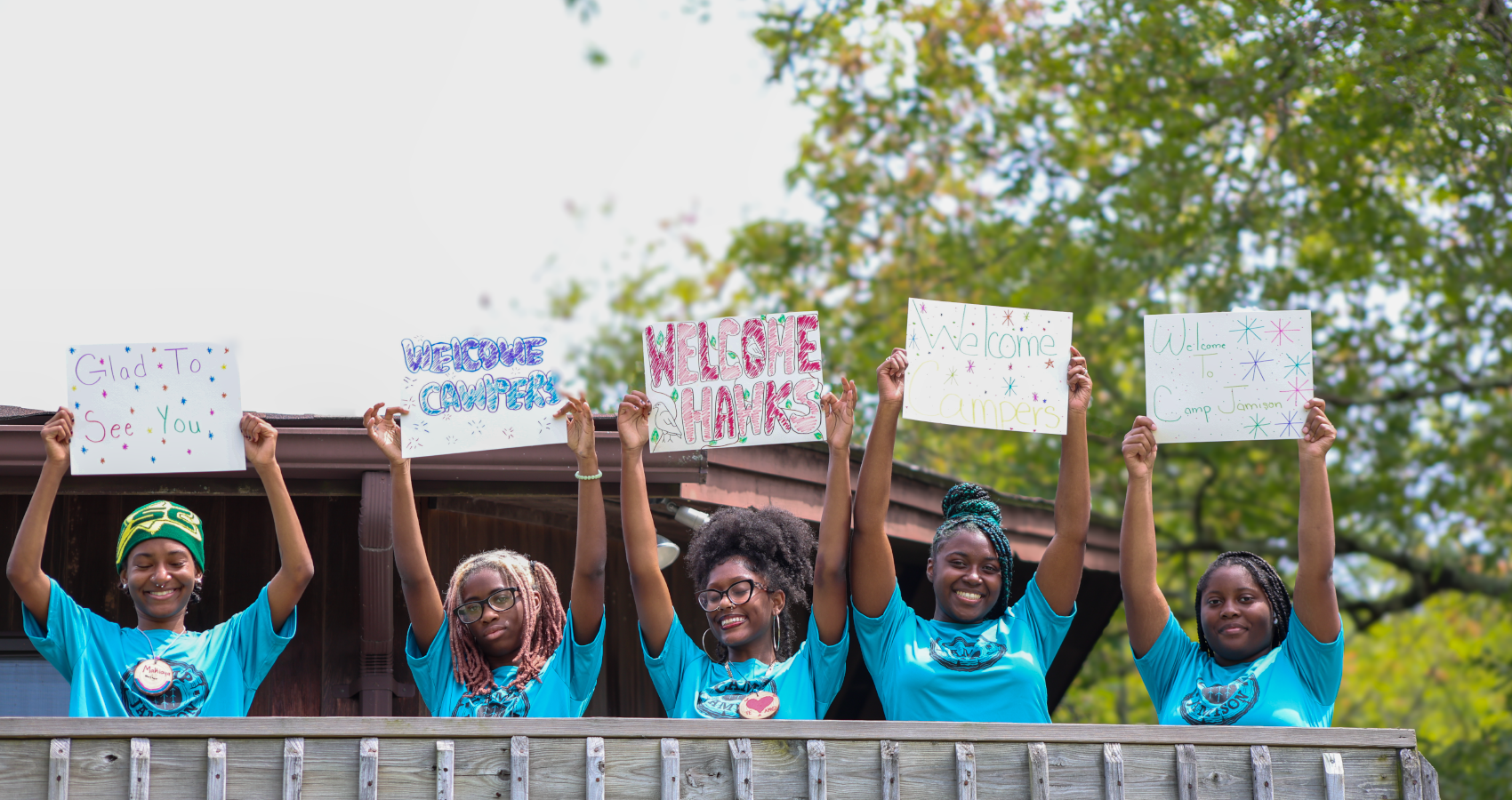 staff welcoming campers