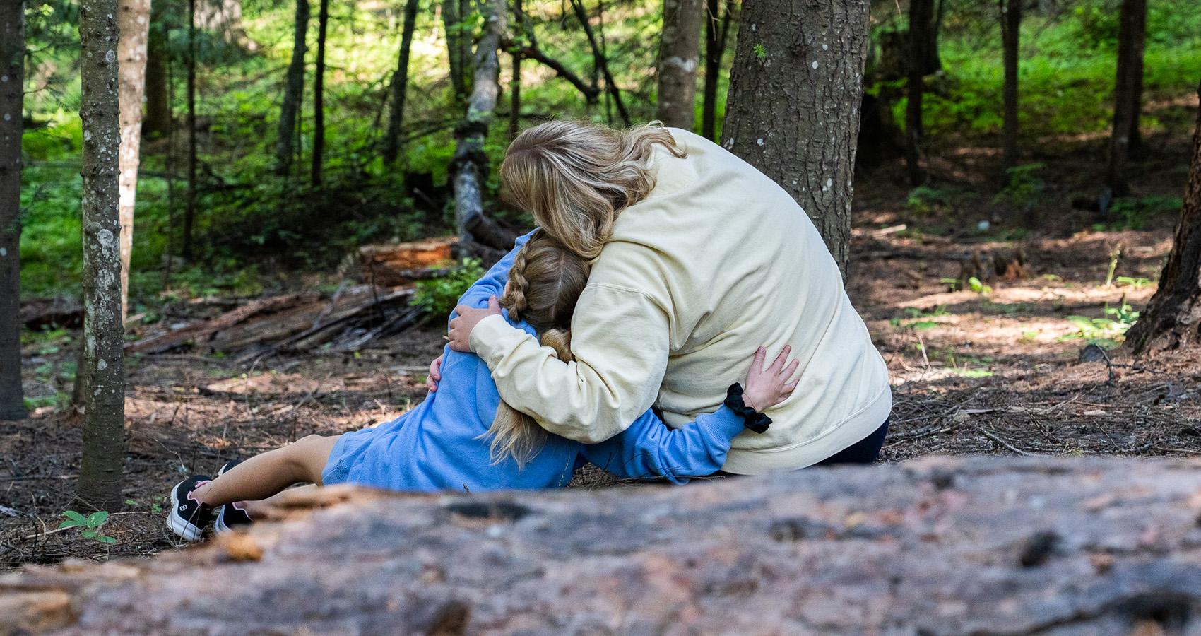 camper and staff hugging