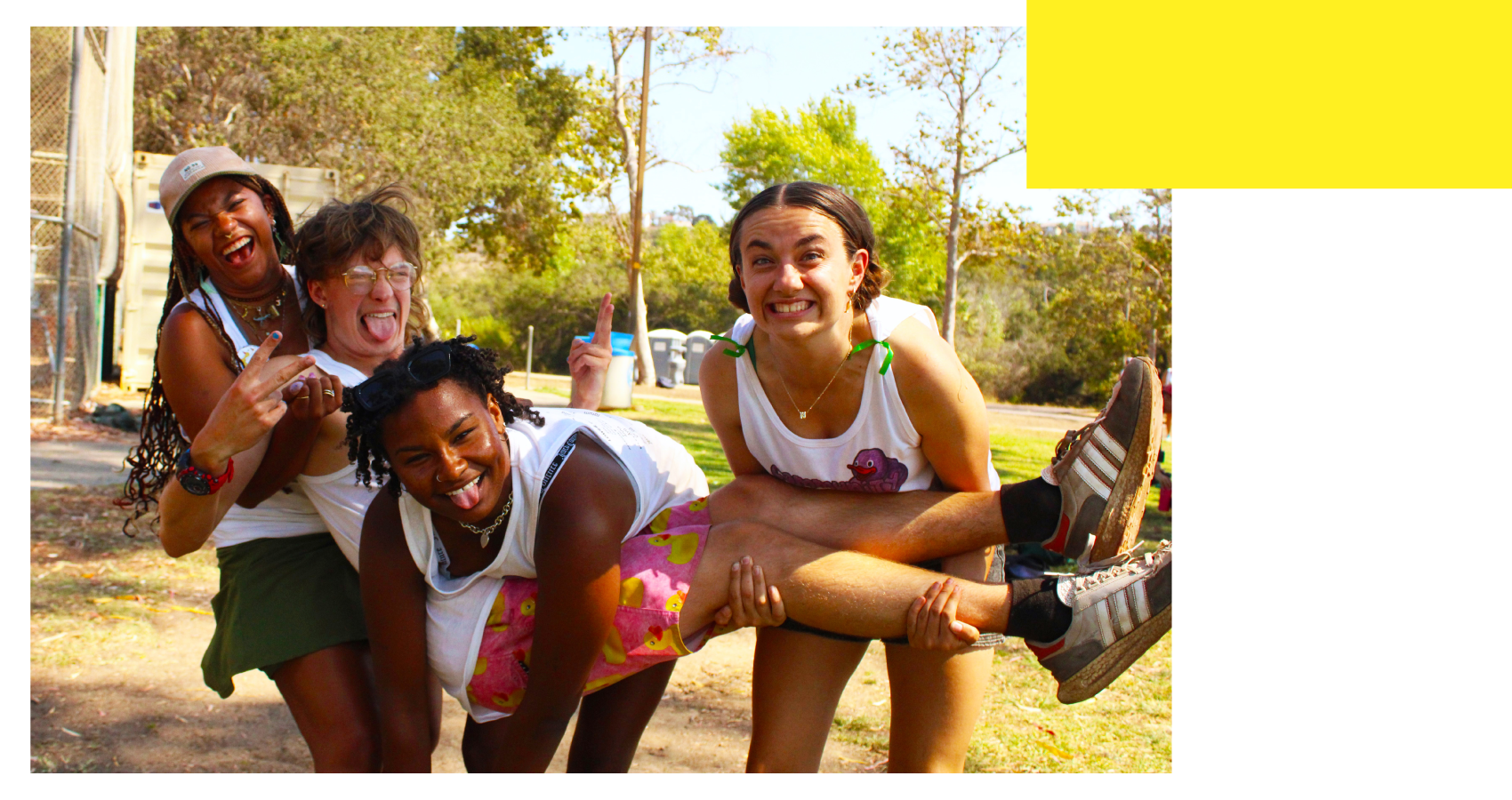Four counselors laughing while holding each other up