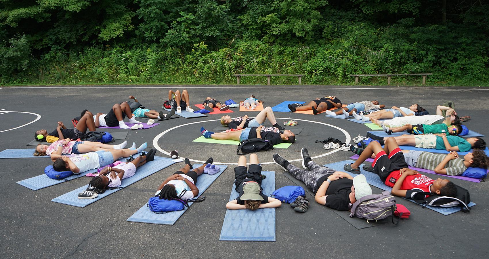 group of campers lying in circle