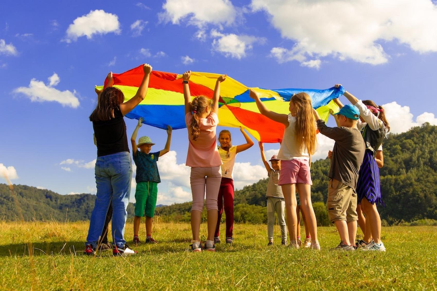 Children at camp in a parachute activity