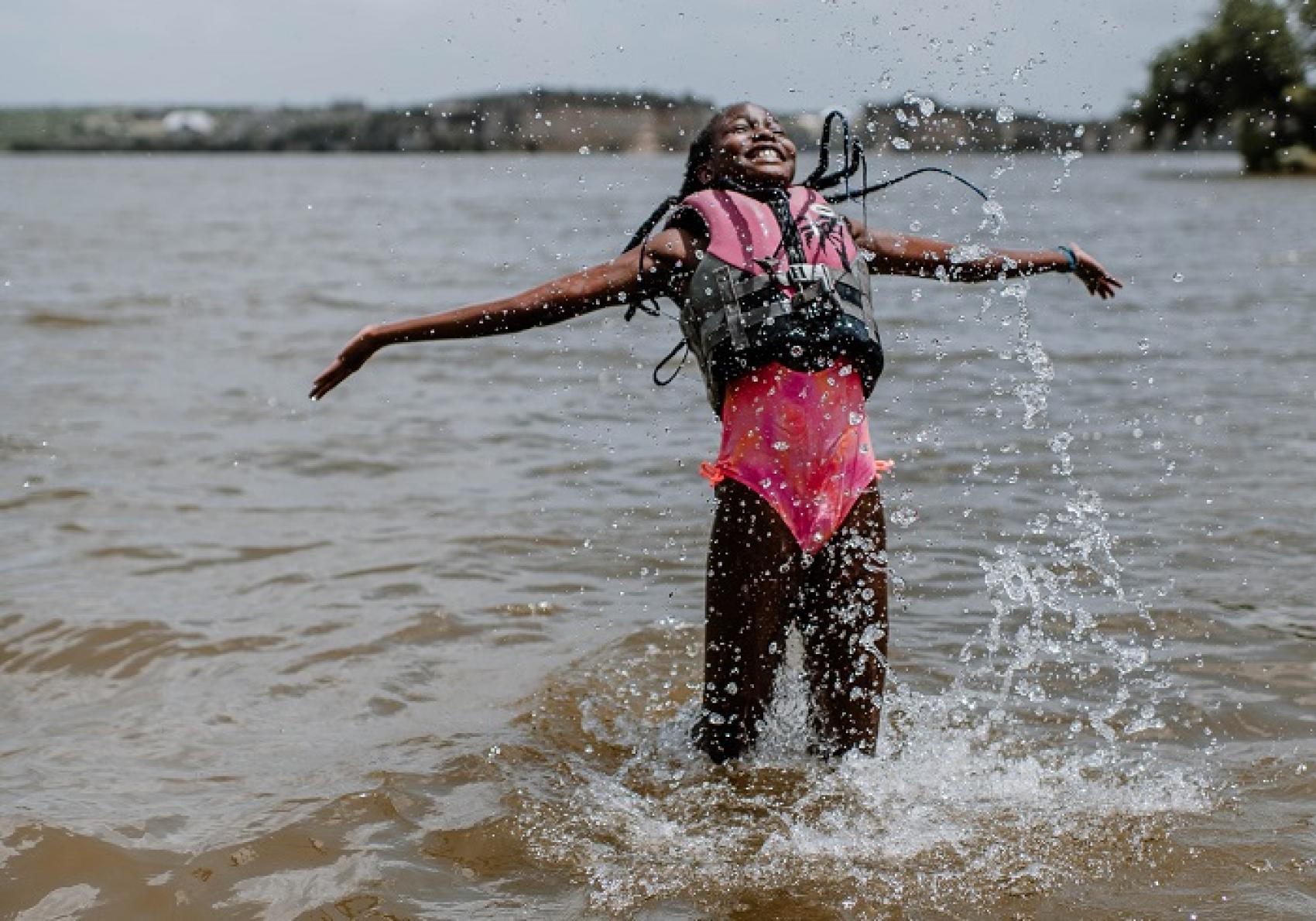 camper wearing life jacket in lake