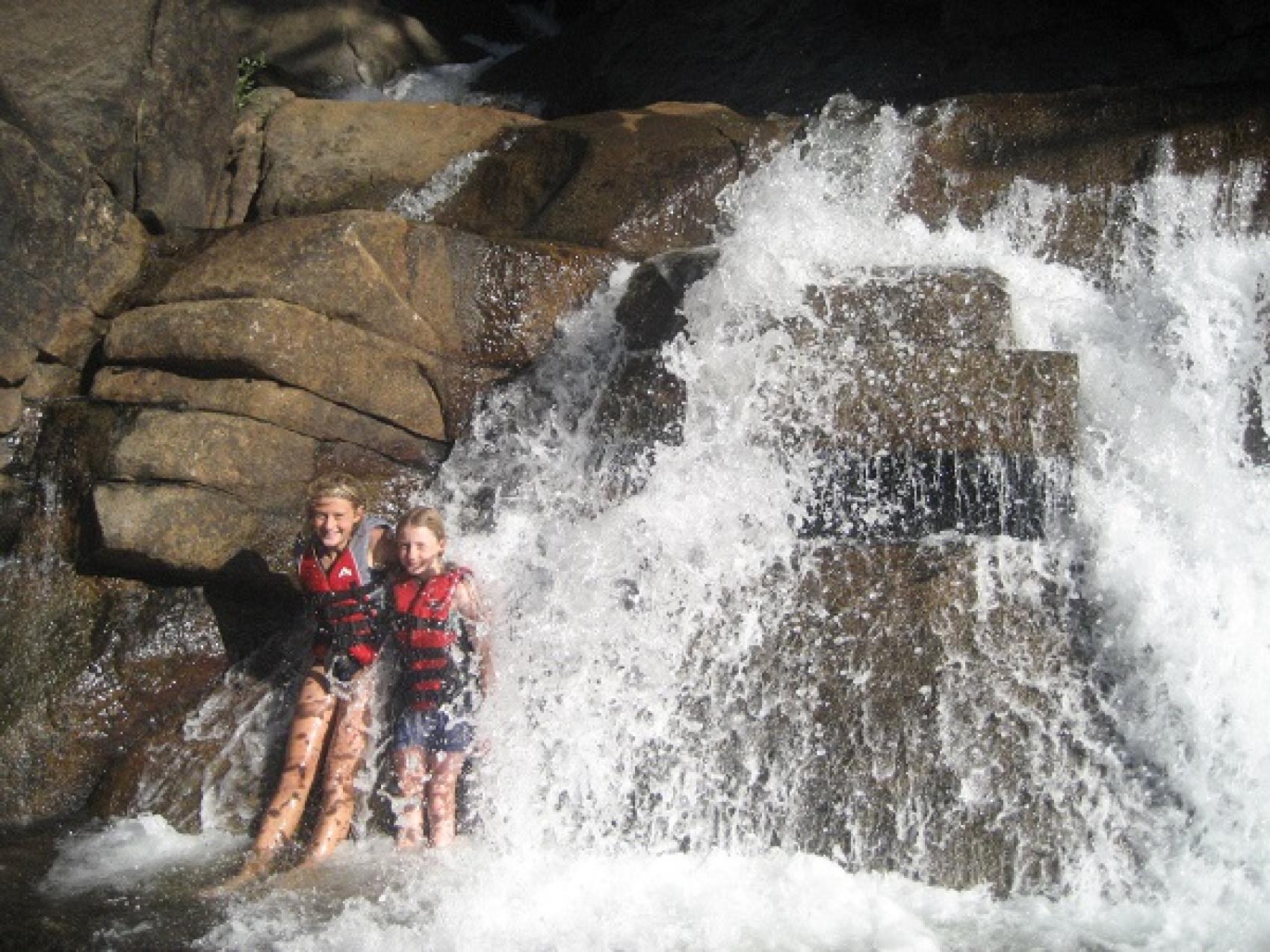 campers at waterfall