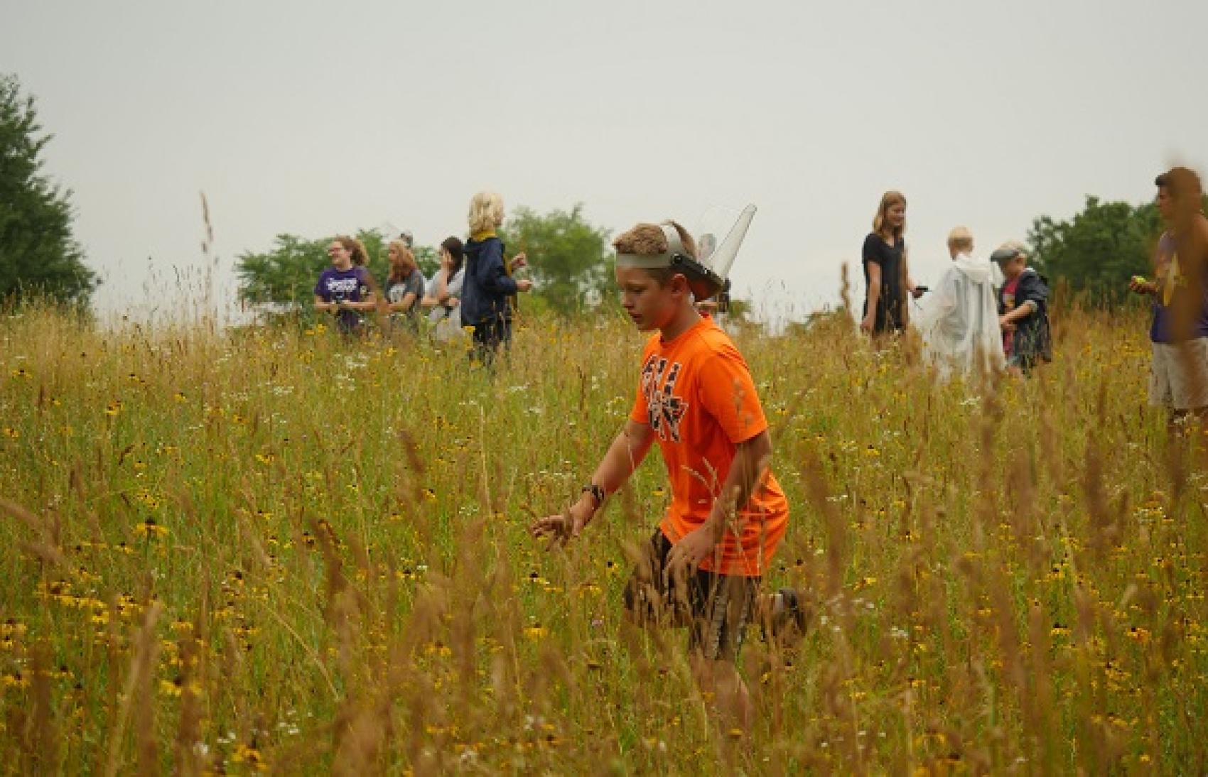 Campers in field with tall grass