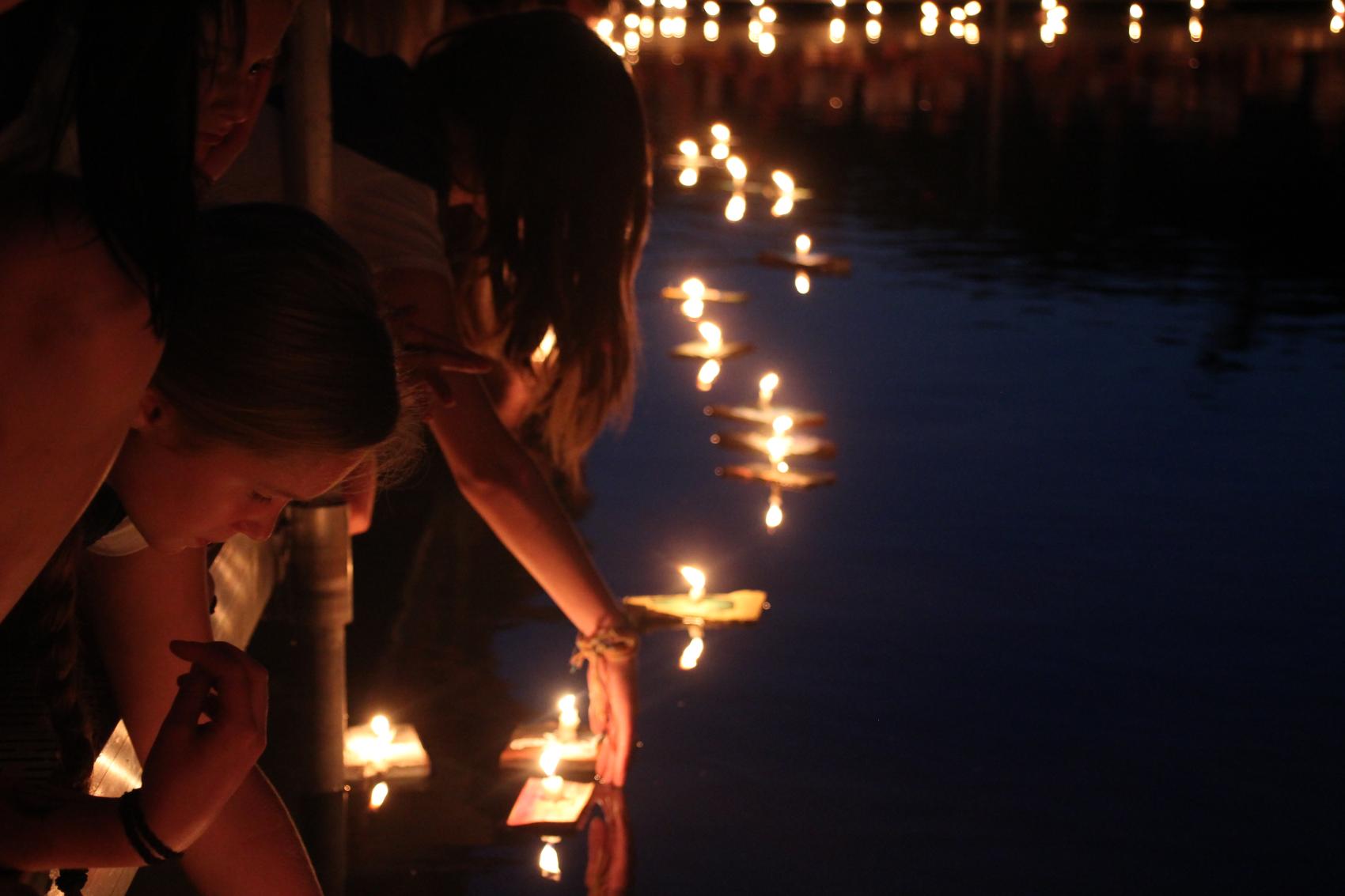 campers releasing wishing boats