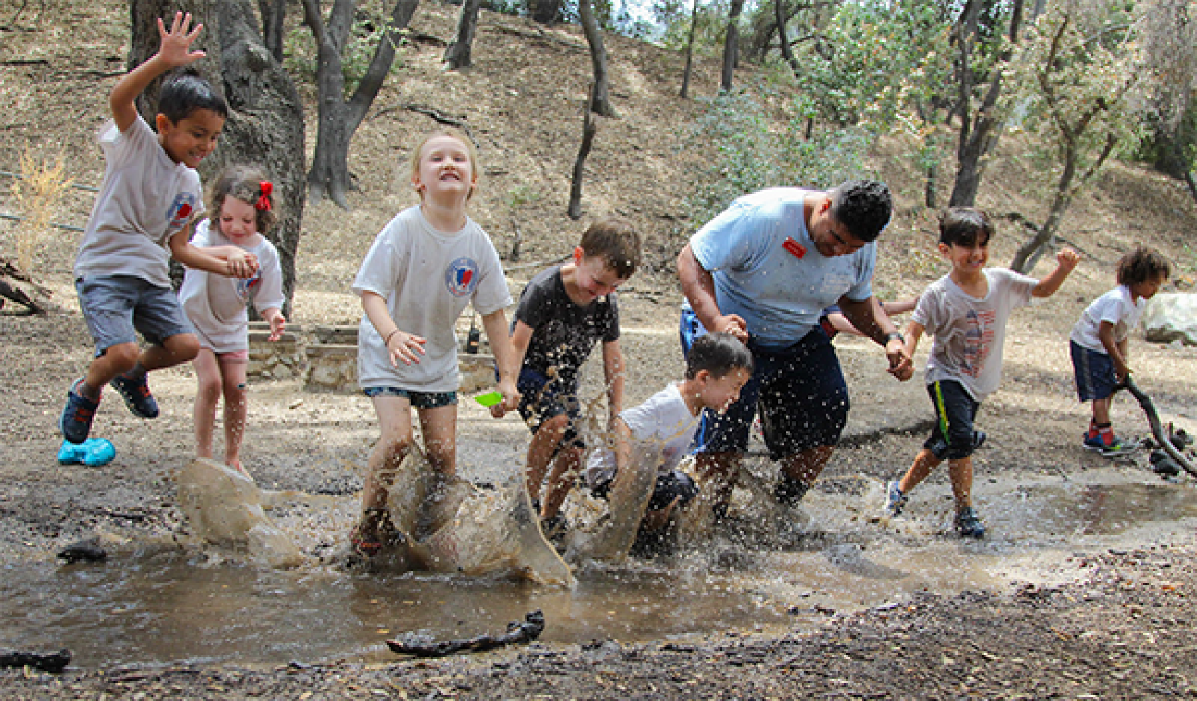 campers and camp stuff jumping in puddles