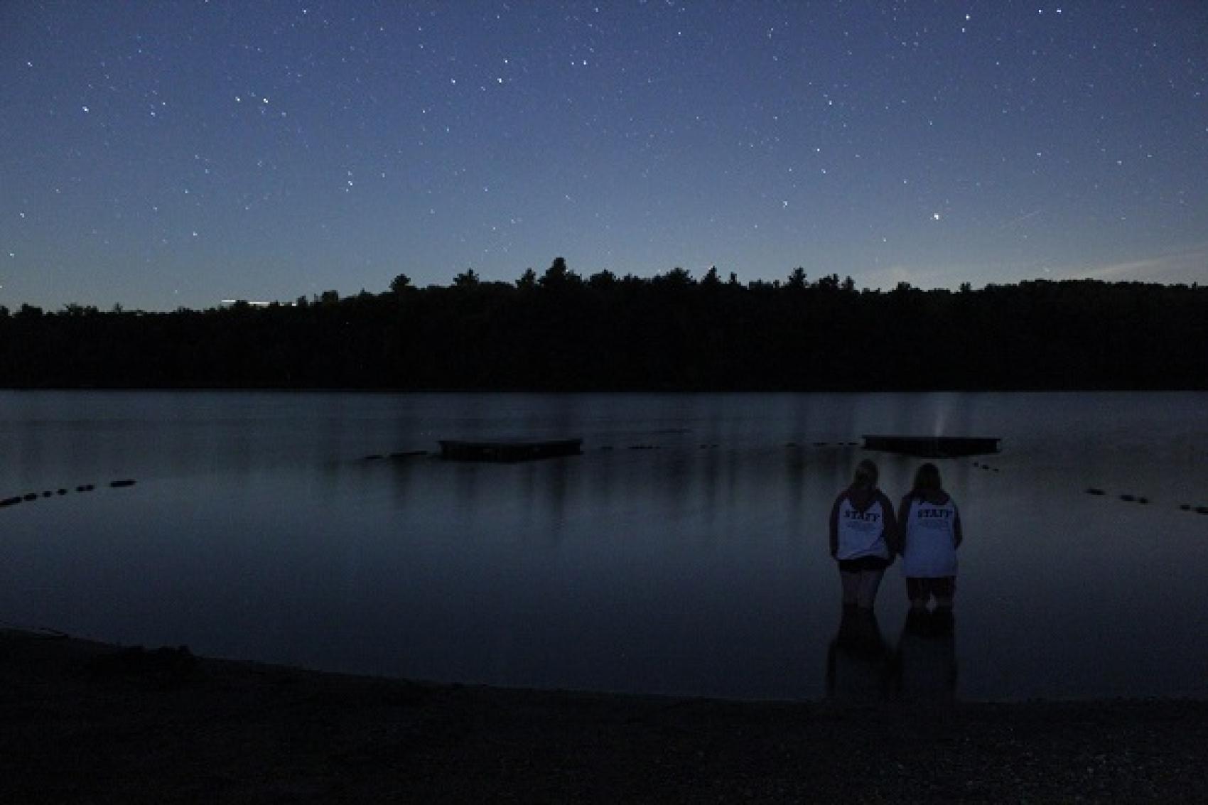 camp staff looking at night sky