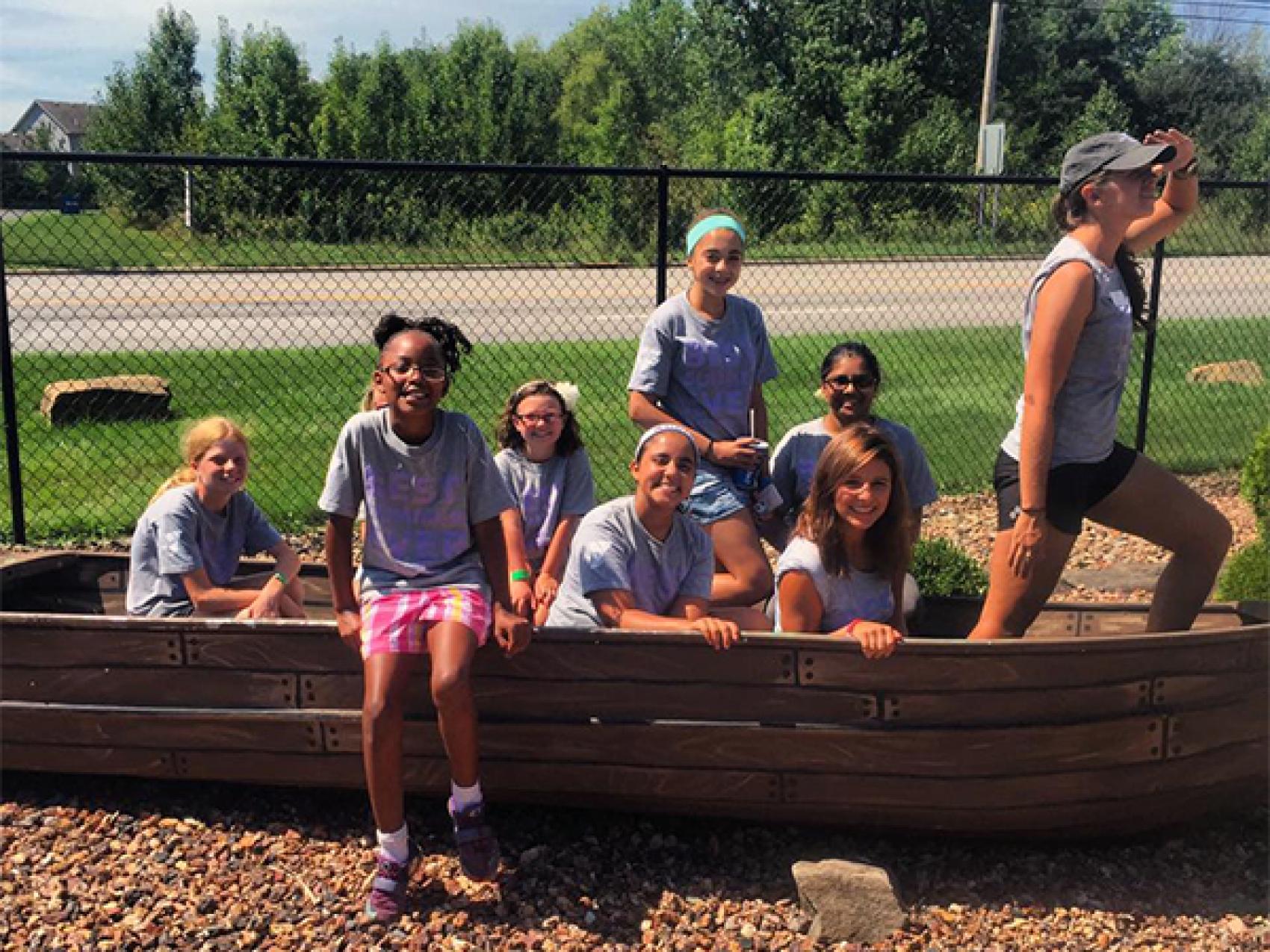 campers posing in a play boat