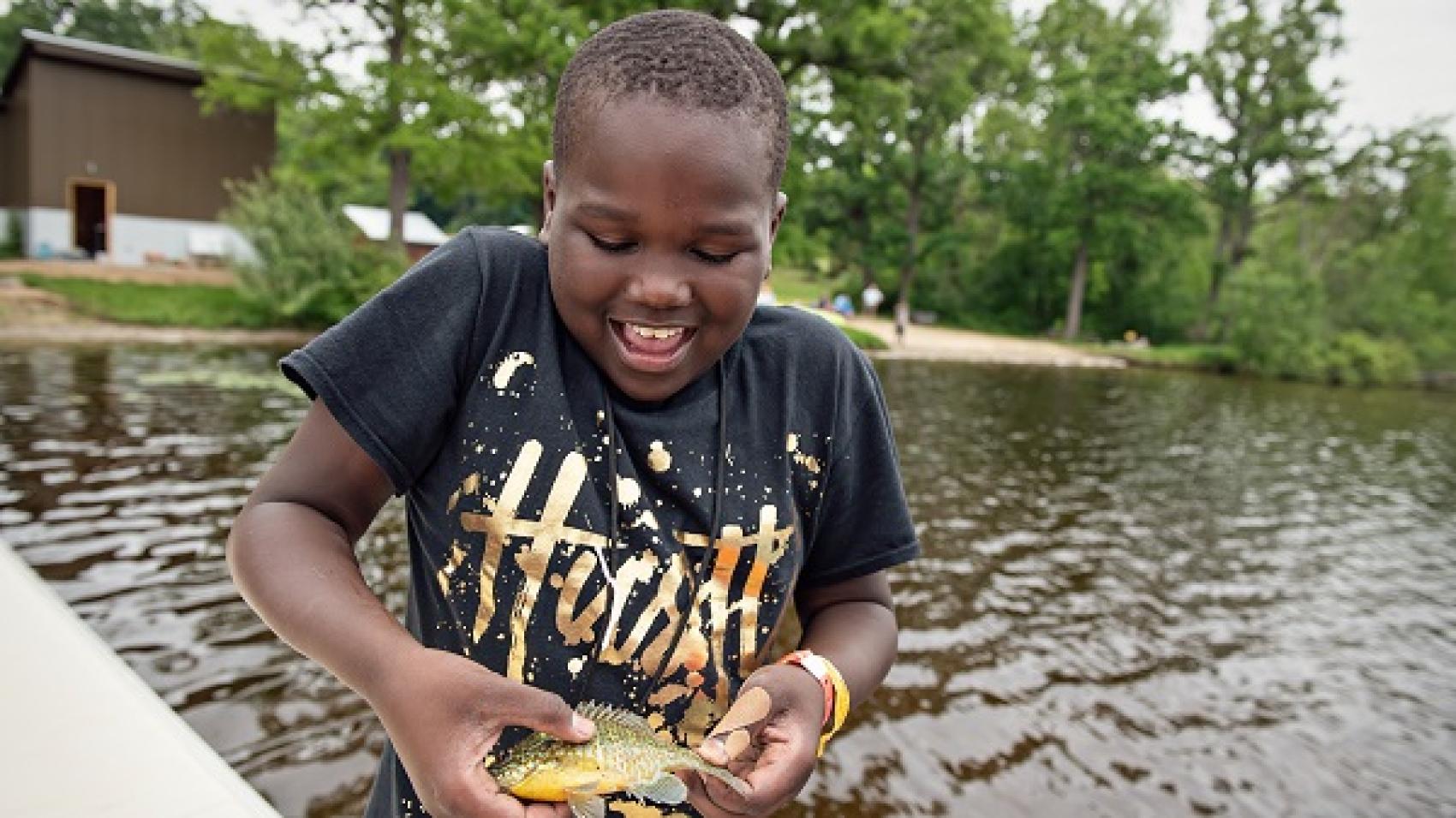 camper holding fish