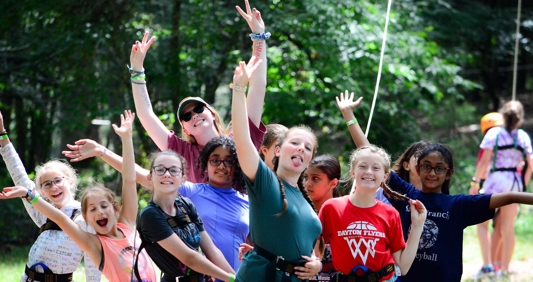 Counselor and campers posing for camera