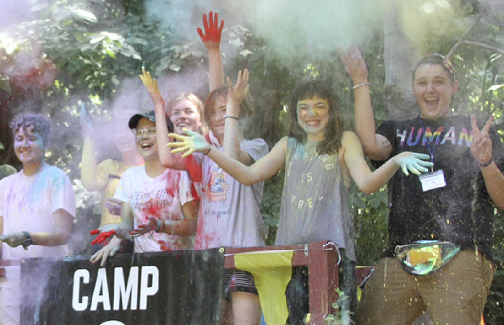 Campers throwing powder up in the air