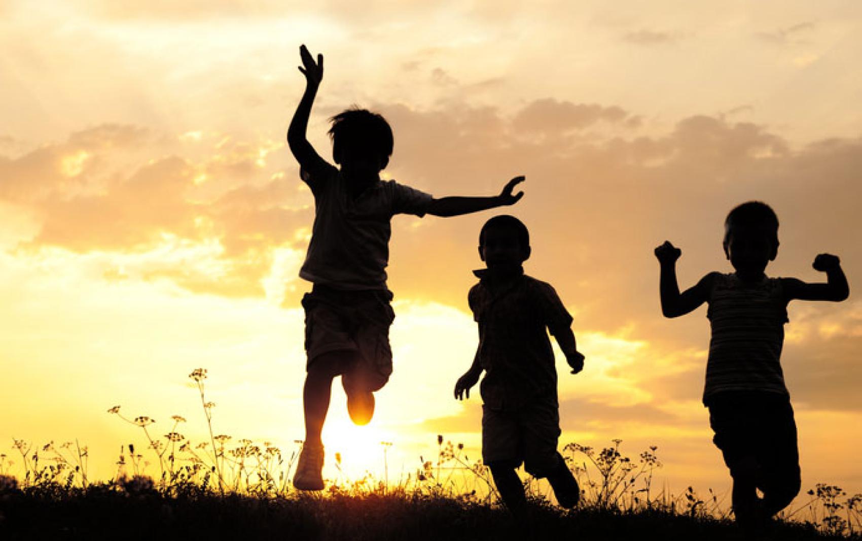 silhouettes of kids at sunset