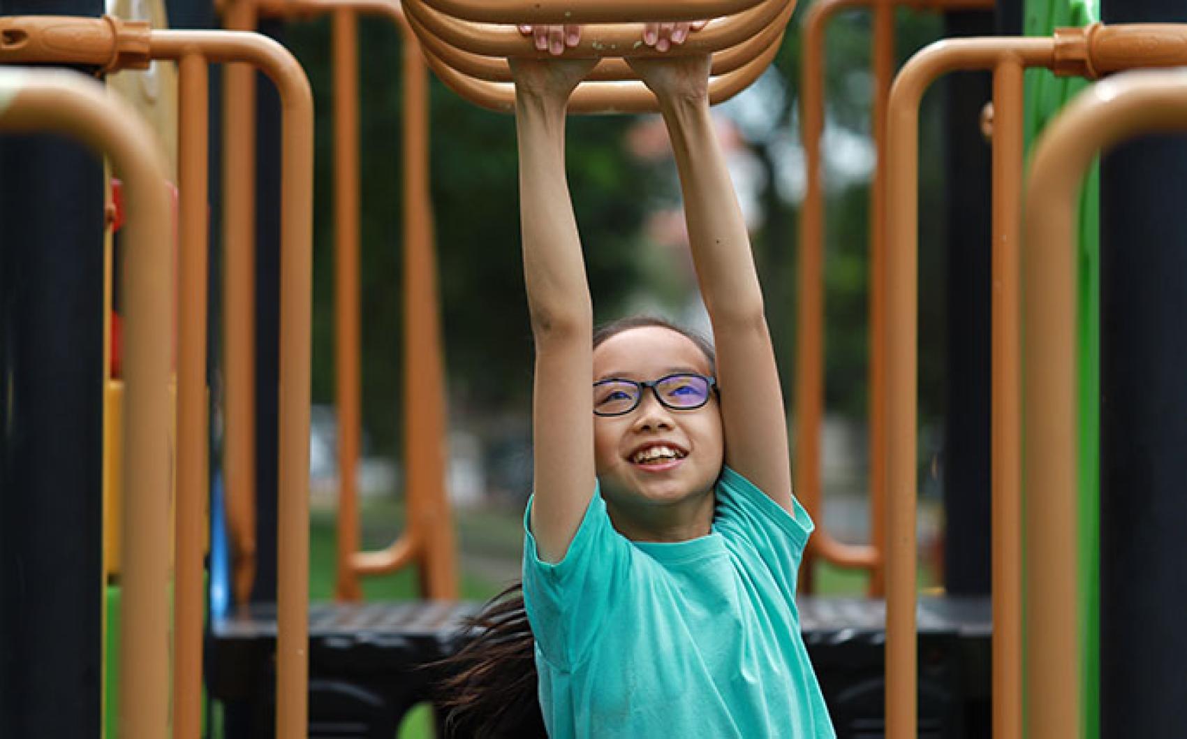 child on monkey bars