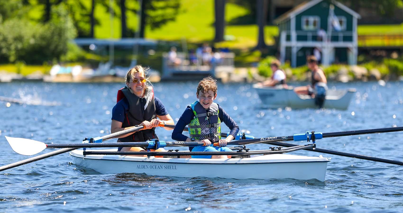 camp staff and camper rowing crew boat