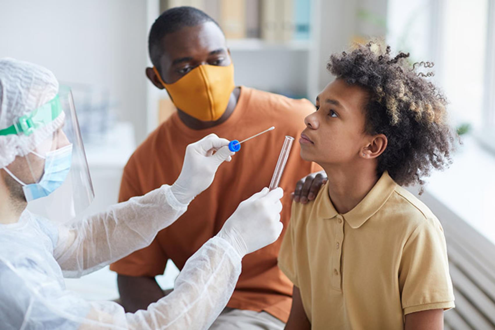 Young boy getting COVID-19 swab test