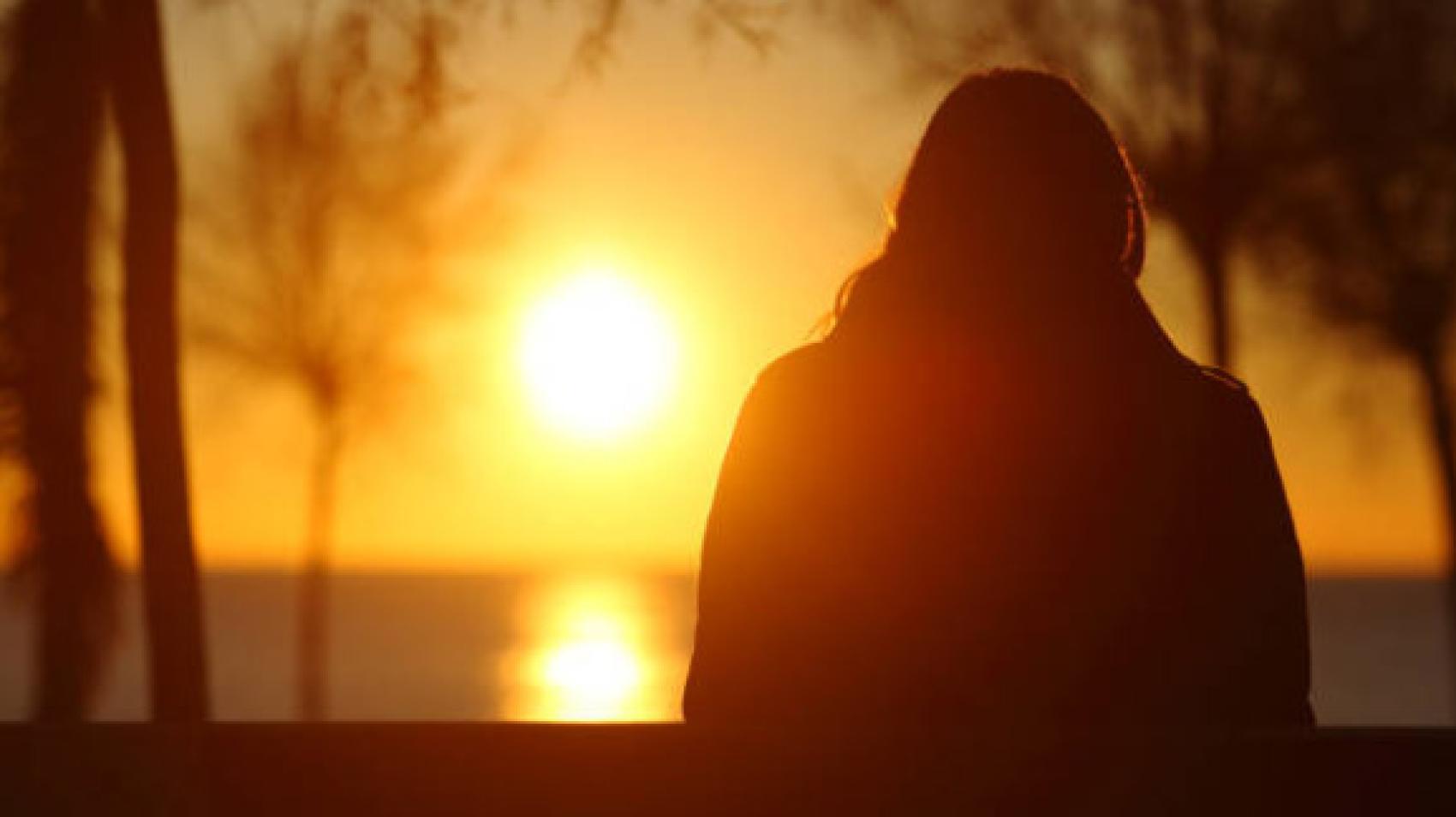 Silhouette of a camper watching sunset