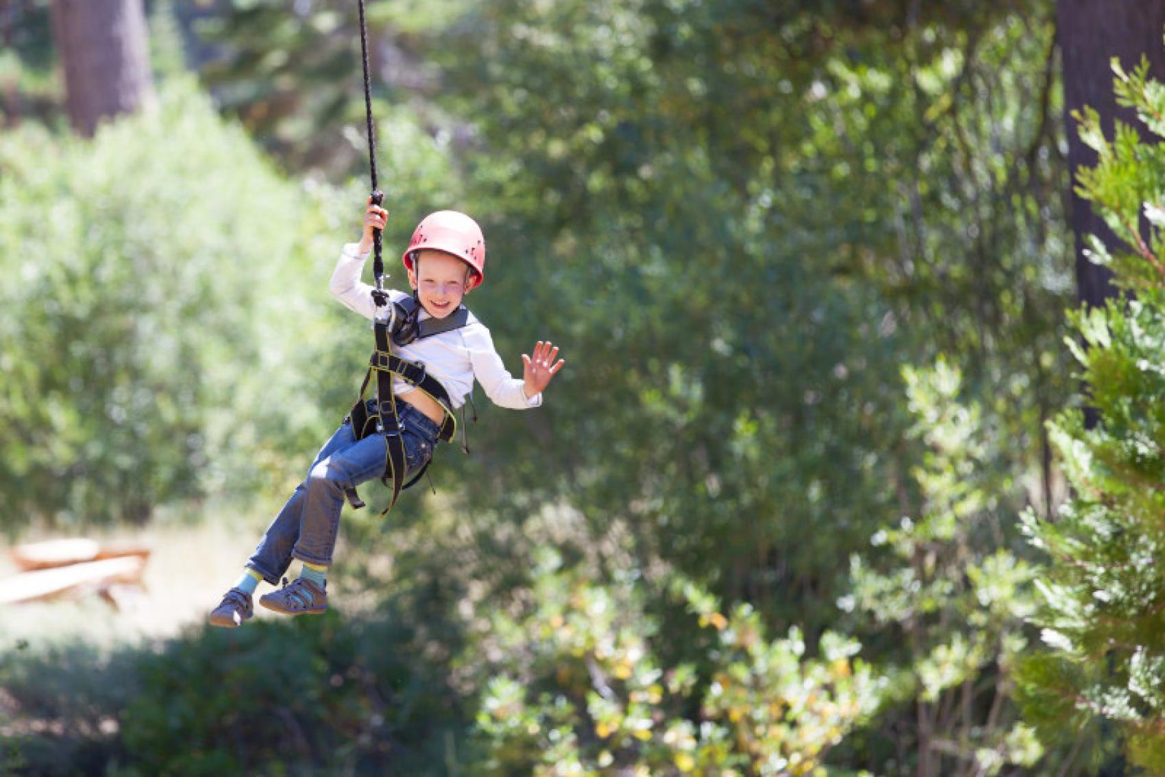 Young boy zip lining