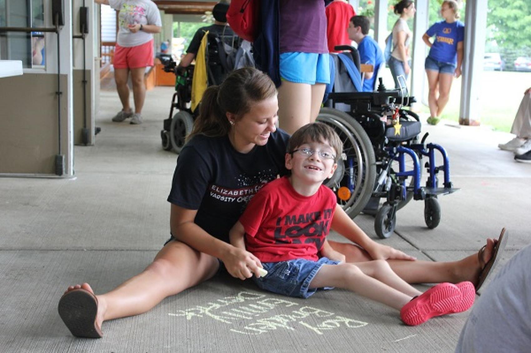 camper in staff doing chalk art