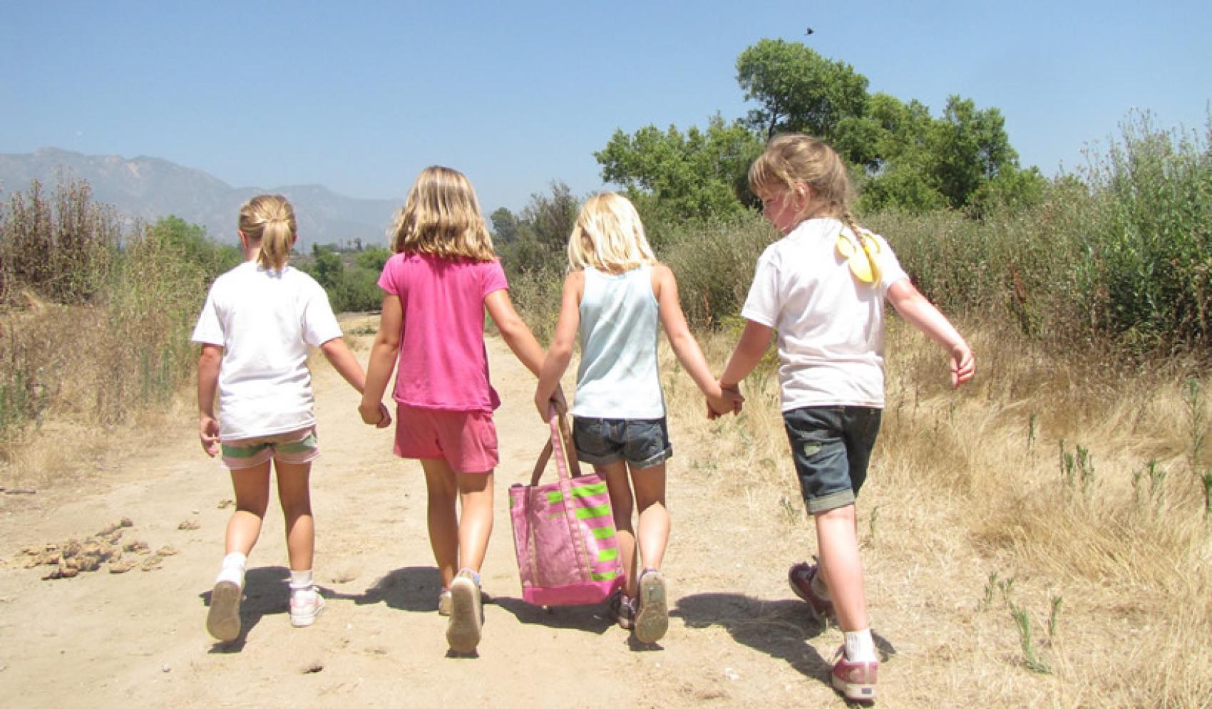 4 girls holding hands - Tom Sawyer Camps
