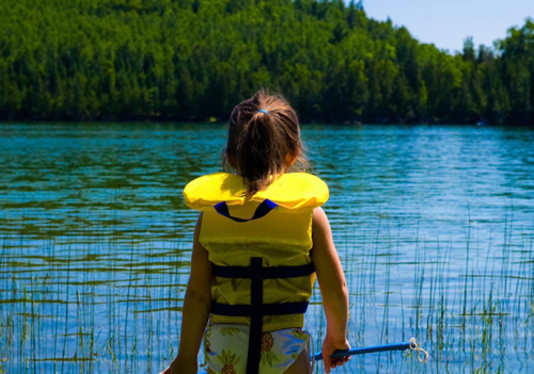 Girl in Lifejacket By Lake