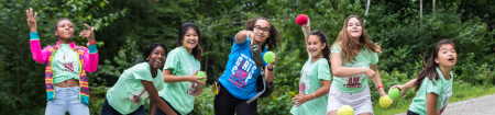 Line of campers throwing balls up in the air