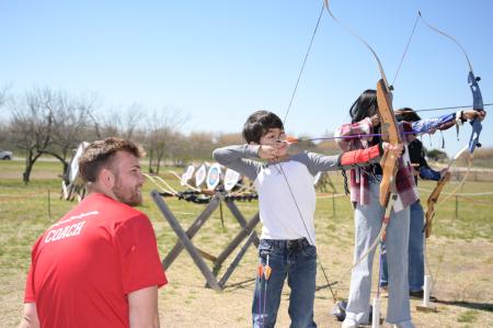 kids holding archery bows and arrows