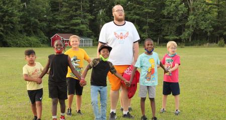 group of campers holding hands