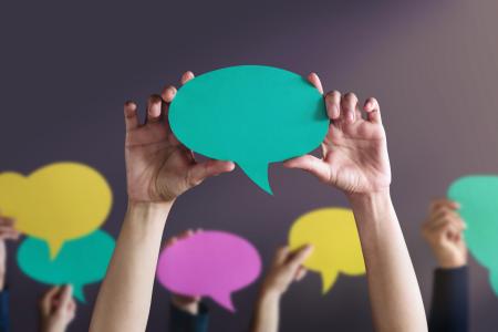 people holding talking bubbles