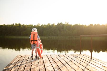 Youth wearing life jacket on boat dock